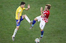 Brazil survives own-goal to win World Cup opener