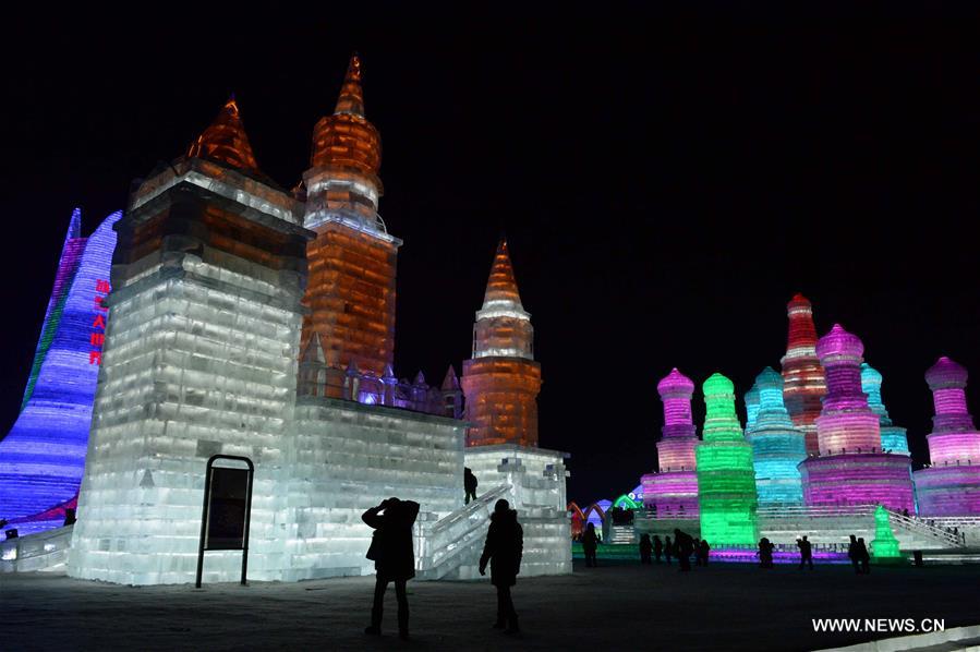 Tourists view shimmering ice sculptures in China's Harbin