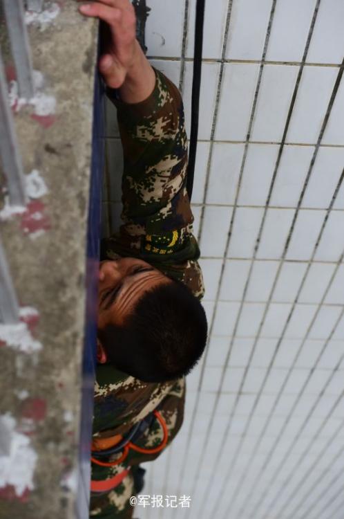 SWAT members run on the wet wall in training