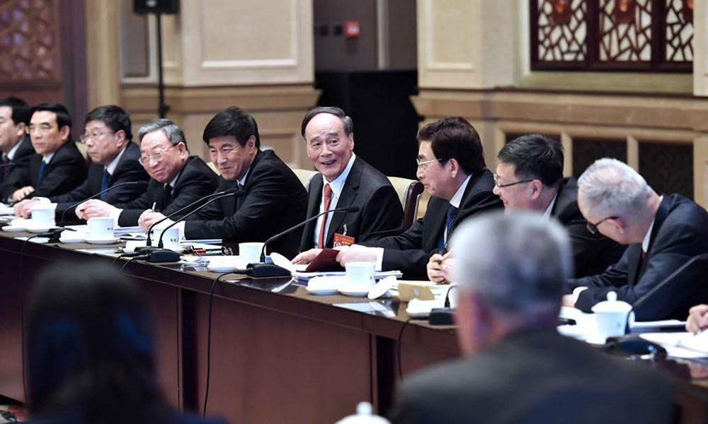 Chinese leaders review gov't work report with lawmakers