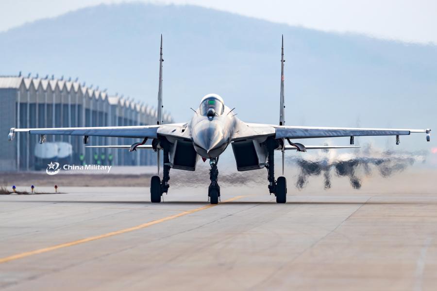 J-11B fighter jet flies past the sun