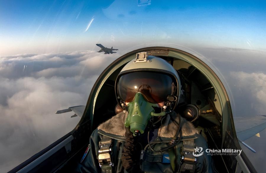 J-11B fighter jet flies past the sun