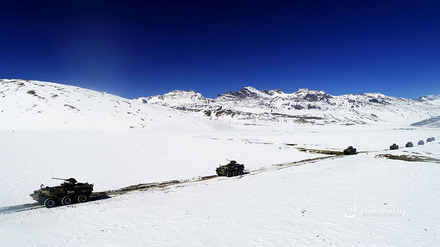 Armored vehicles maneuver in snow-covered area