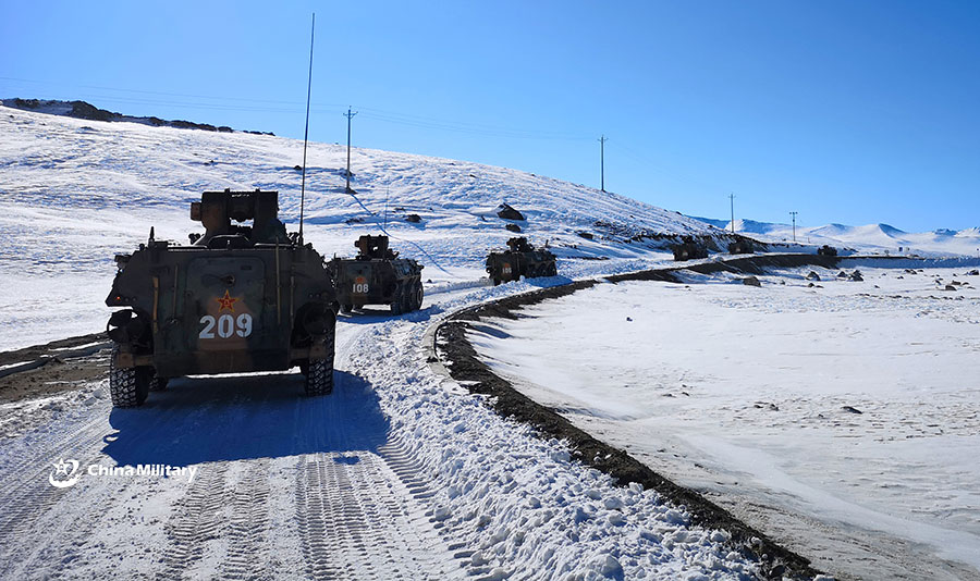Armored vehicles maneuver in snow-covered area