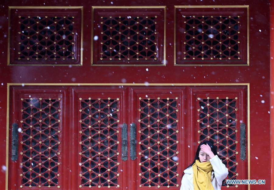Visitors view snowy scenery at Palace Museum in Beijing