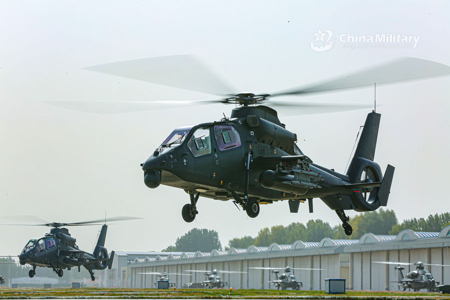 Multi-type attack helicopters hover at low altitude