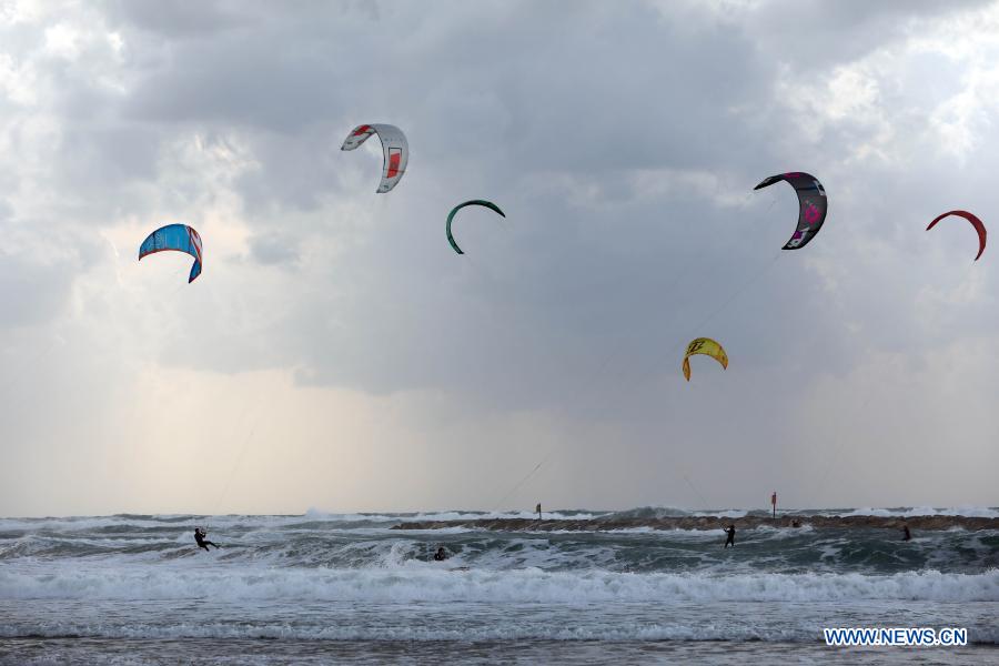 Israeli kite surfers practice on Mediterranean beach