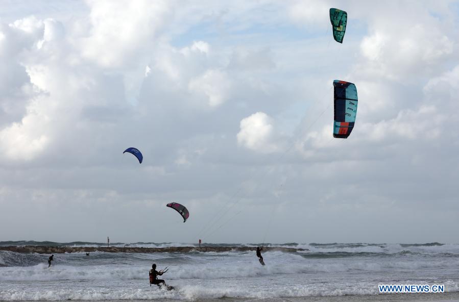 Israeli kite surfers practice on Mediterranean beach