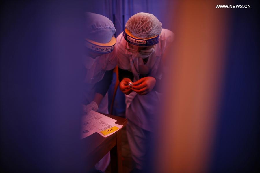 Medical workers work at vaccination room in Kathmandu, Nepal