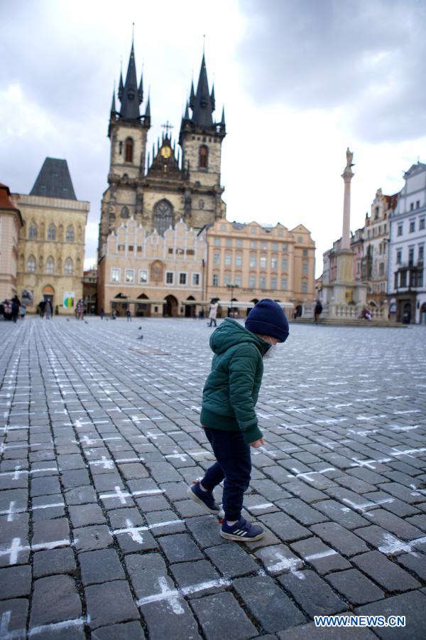 Old Town Square painted with white crosses in memory of victims of COVID-19 pandemic in Prague