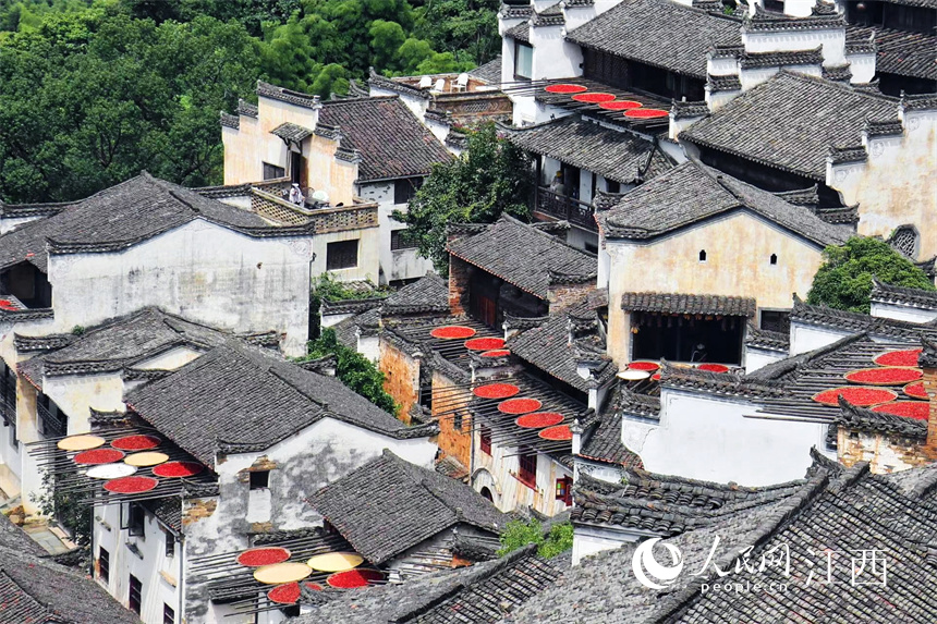 Villagers dry crops in the sun in Wuyuan, E China's Jiangxi