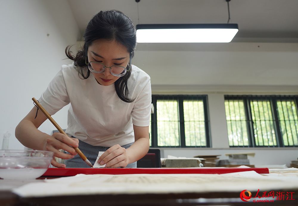 Repairers bring damaged ancient books back to life