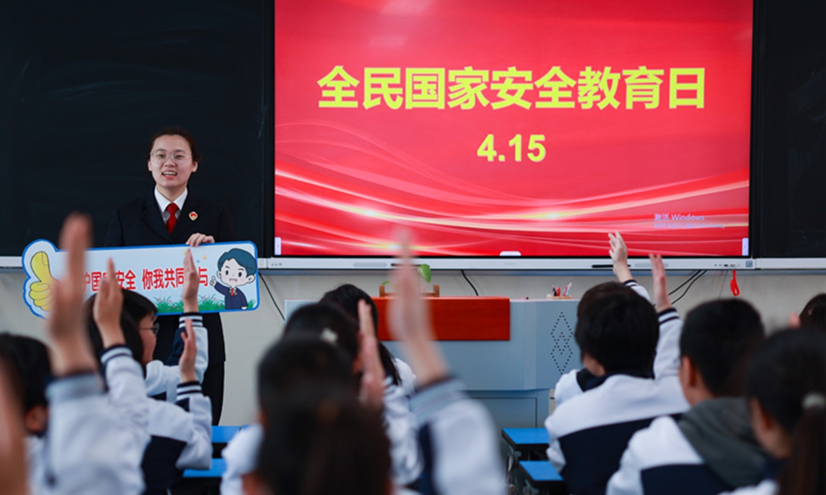 Staff from the legal education promotion ream of the People's Procuratorate of Xinghua, East China's Jiangsu Province, go to Wenfeng Junior High School to teach students about national security through interactive Q&A sessions on April 14, 2025. Photo: Xinhua