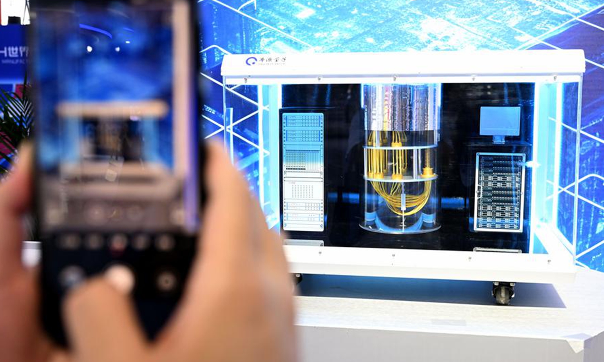 A visitor takes photos of an Origin Wukong superconducting quantum computer model at the 2024 World Manufacturing Convention in Hefei, east China's Anhui Province, Sept. 20, 2024. (Xinhua/Huang Bohan)