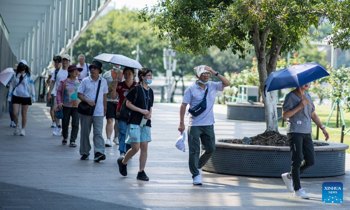 Tourists visit Qianjiang New City in Hangzhou, east China's Zhejiang Province, July 3, 2025. Hangzhou issued an orange heat alert on Thursday. Photo: Xinhua