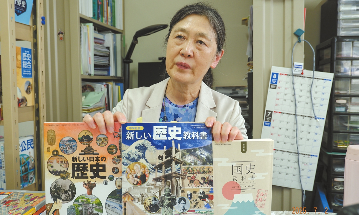 Yoko Kojiya, secretary-general of the Children and Textbooks Japan Network 21, a non-governmental organization, displays various versions of Japanese history textbooks to Global Times reporters on July 2, 2025. Photo: Xu Keyue/GT